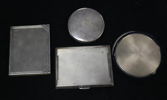 Two silver compacts and two engine turned silver cigarette cases including one modelled as a book.